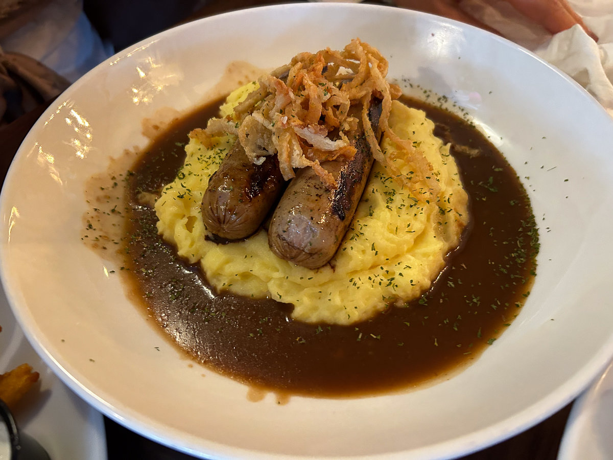 sausage and mashed potatoes with crispy fried onions on top